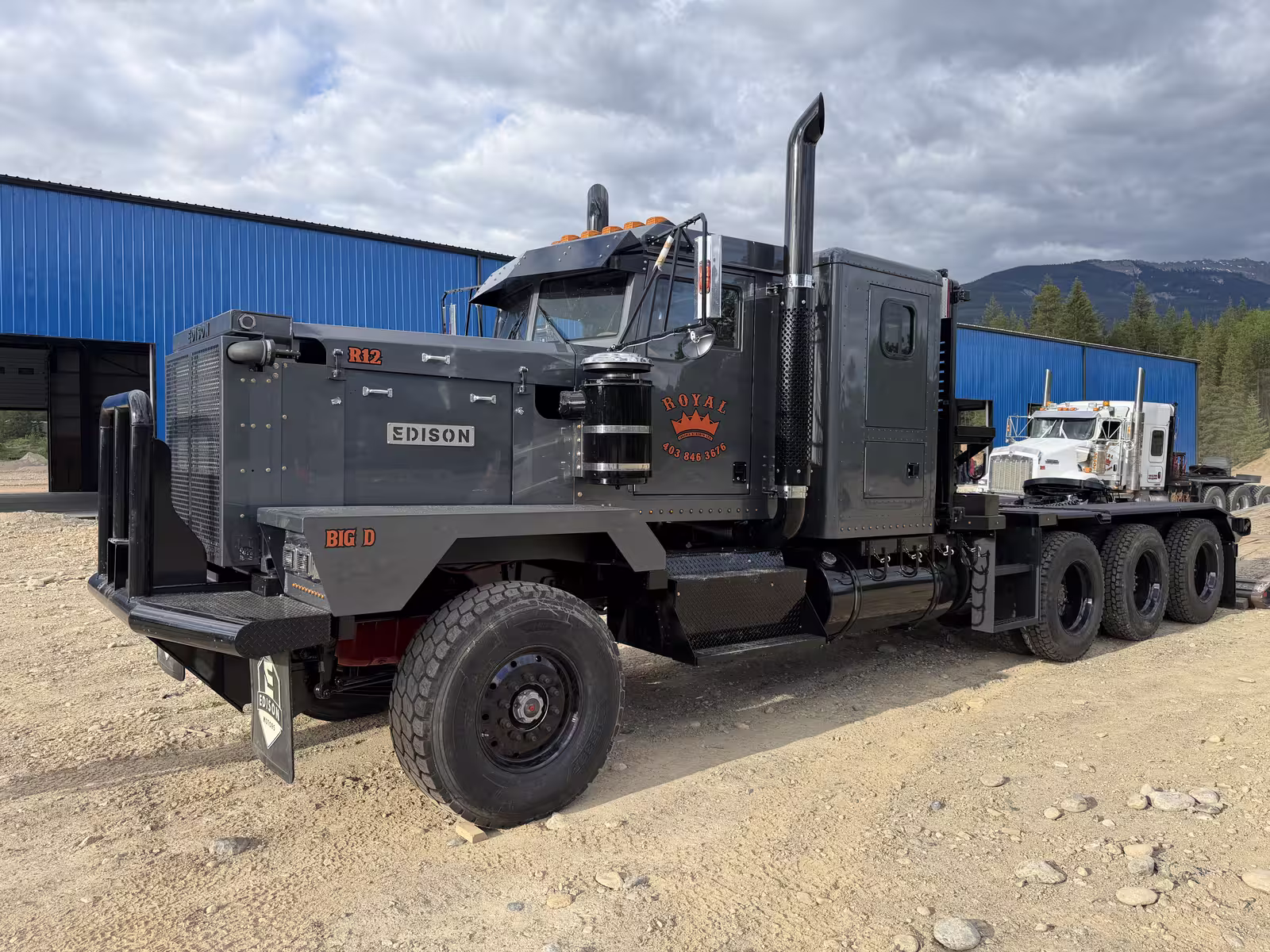 Royal Oilfield R12 tri-drive winch tractor parked outside the Edison Motors shop