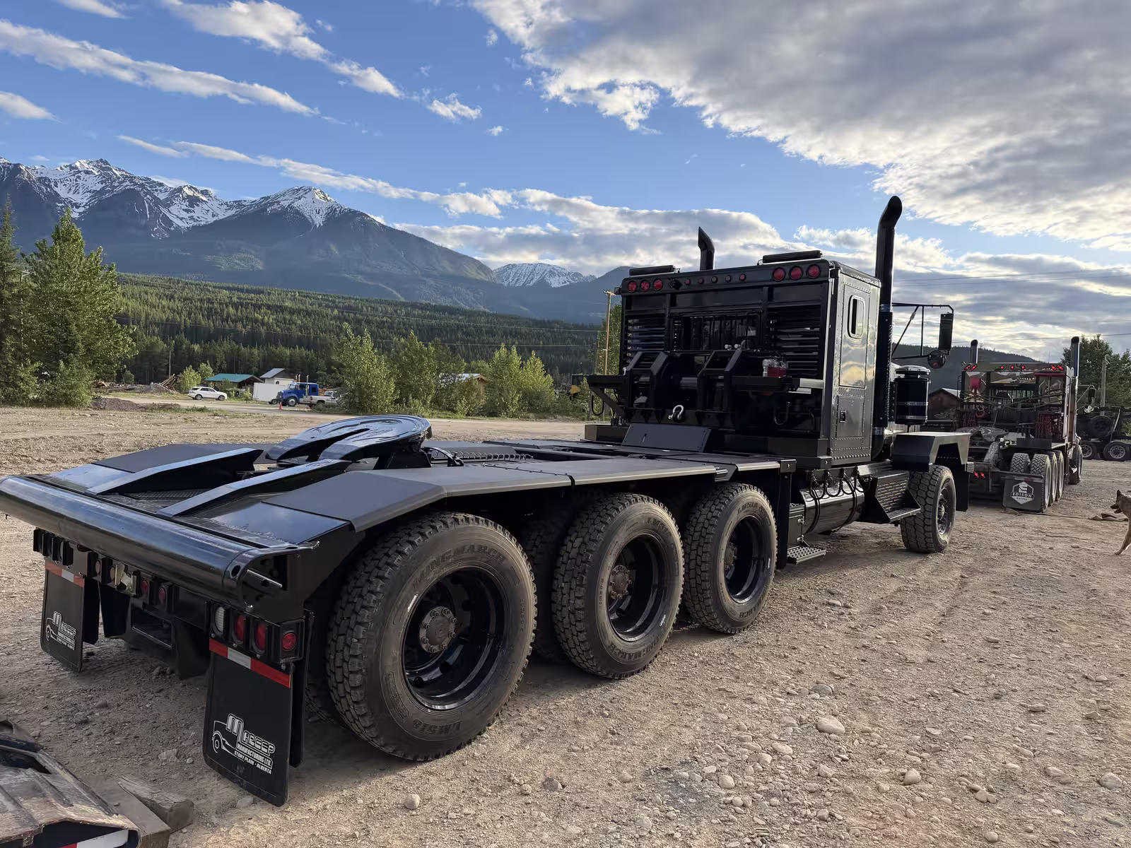 Edison tri-drive winch tractor with winch deck, mountain backdrop